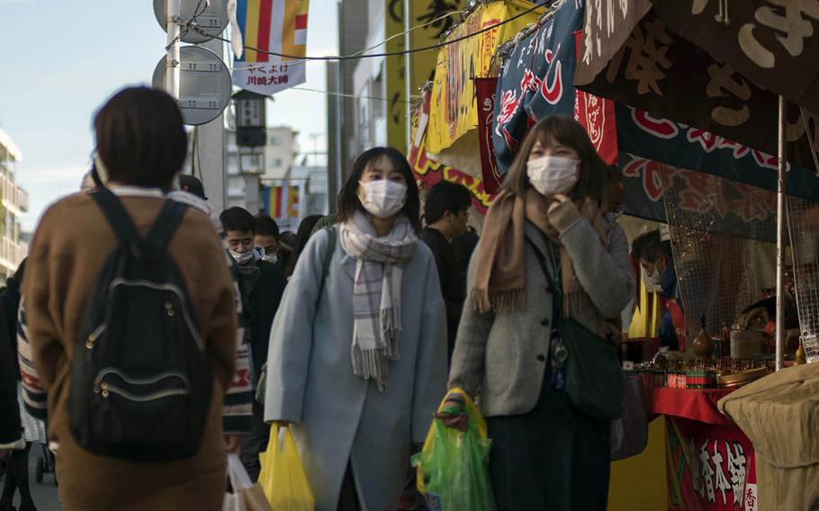 Visitors to Kawasaki-Daishi temple in Kanagawa prefecture, Japan, wear masks to guard against a coronavirus, Jan. 4, 2021. 