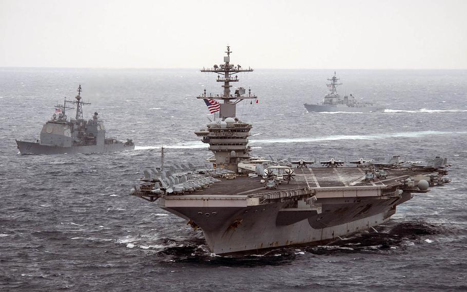 The aircraft carrier USS Theodore Roosevelt, front, the guided-missile cruiser USS Bunker Hill, left, and the guided-missile destroyer USS John Finn sail together somewhere in the Pacific Ocean, Jan. 15, 2021. 