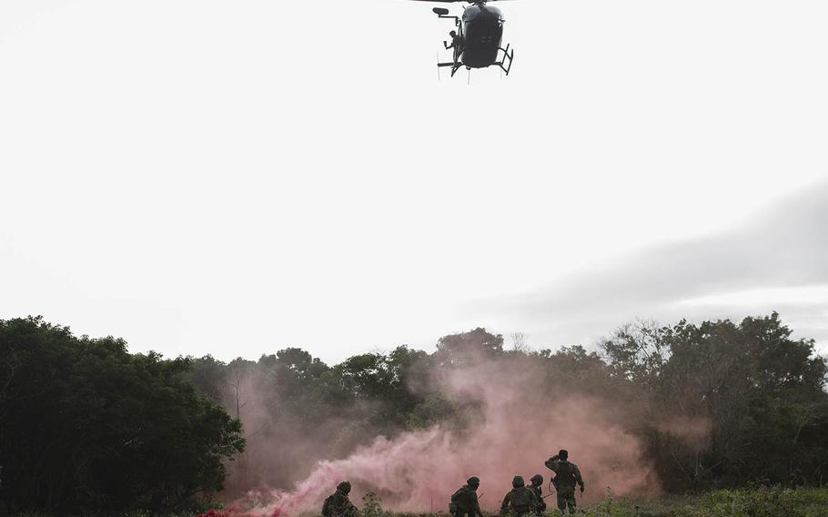 Airmen await a Guam Army National Guard medical helicopter during an exercise at Northwest Field, Guam, Jan. 13, 2021. 