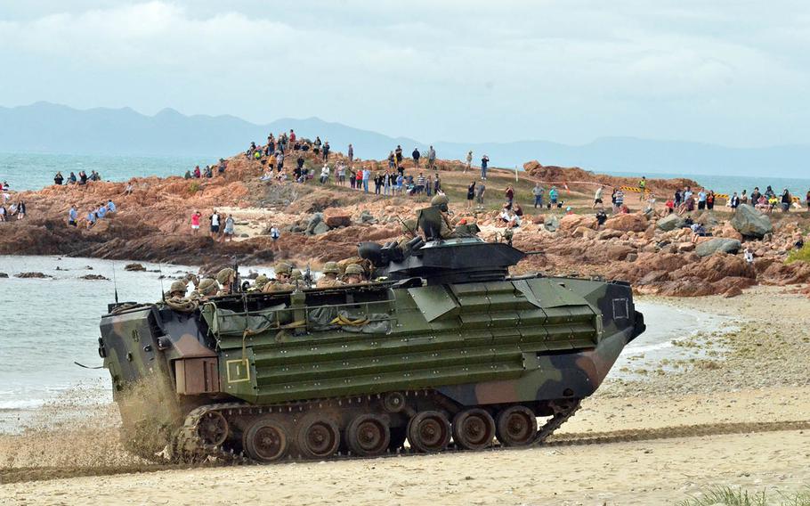 Locals watch U.S. Marines move along Kings Beach, Australia, in an assault amphibious vehicle during a Talisman Sabre drill, July 22, 2019.