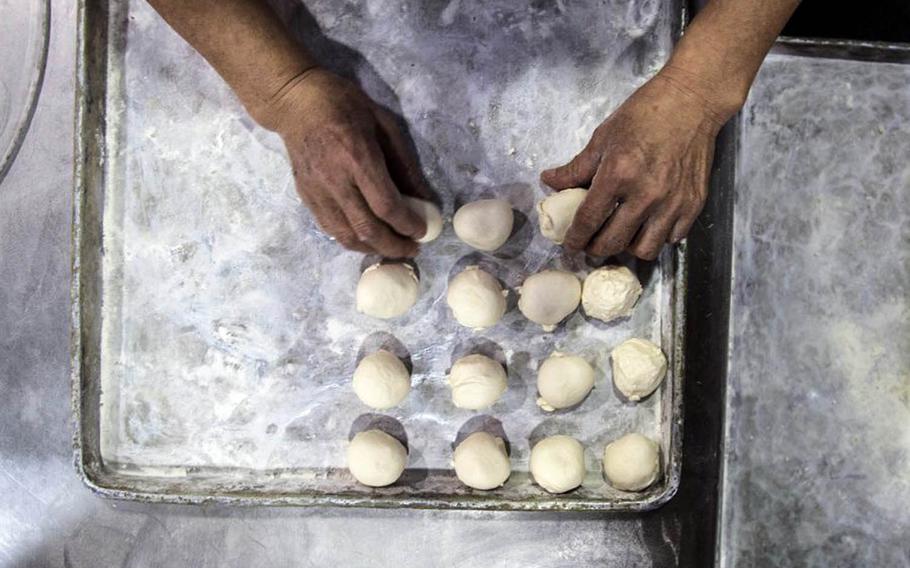 A baker makes pastries at the Army and Air Force Exchange Service bakery at Camp Market, South Korea, Dec. 5, 2017.