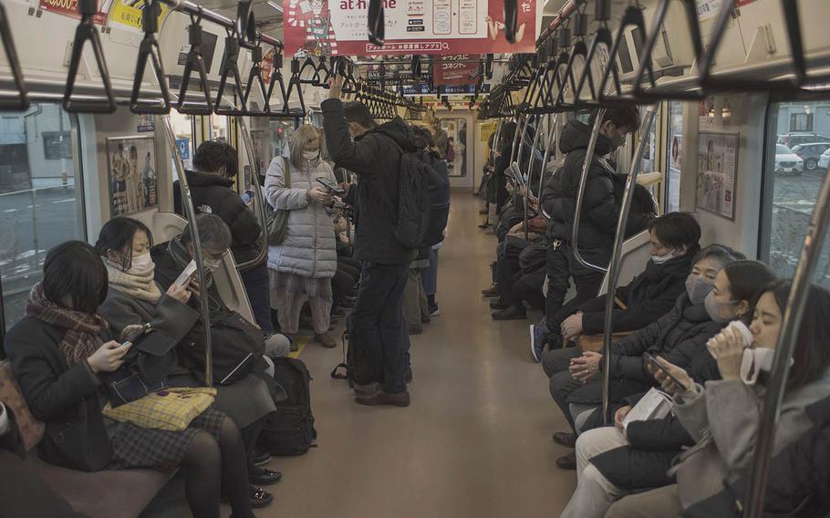 A commuter train departs Hachioji Station in western Tokyo, Feb. 2, 2021. 