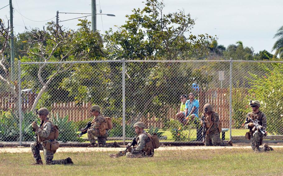 Locals watch U.S. Marines train in the Australian state of Queensland, July 22, 2019. 