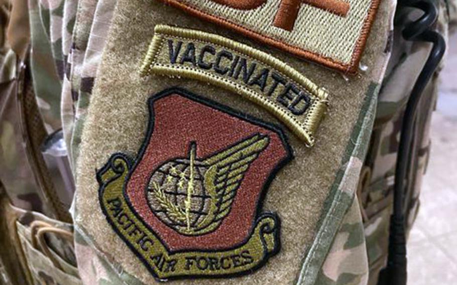 A security forces airman wears a "vaccinated" morale patch in this screenshot from the popular Air Force amn/nco/snco Facebook page.