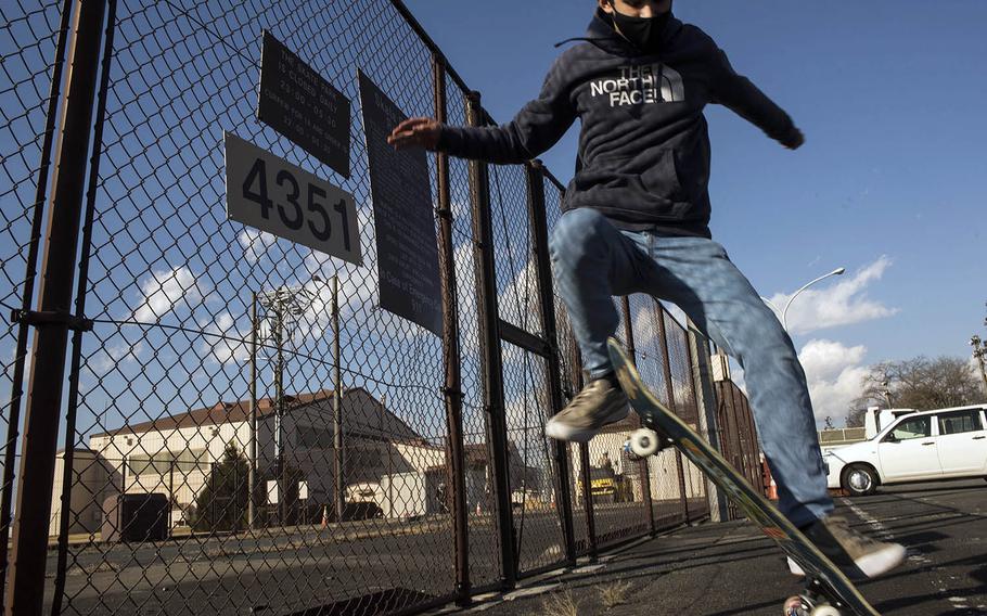 Yokota High School student Kai Patton, 14, performs a ground trick near the site of a demolished skate park at Yokota Air Base, Japan, Tuesday, Feb. 9, 2021.