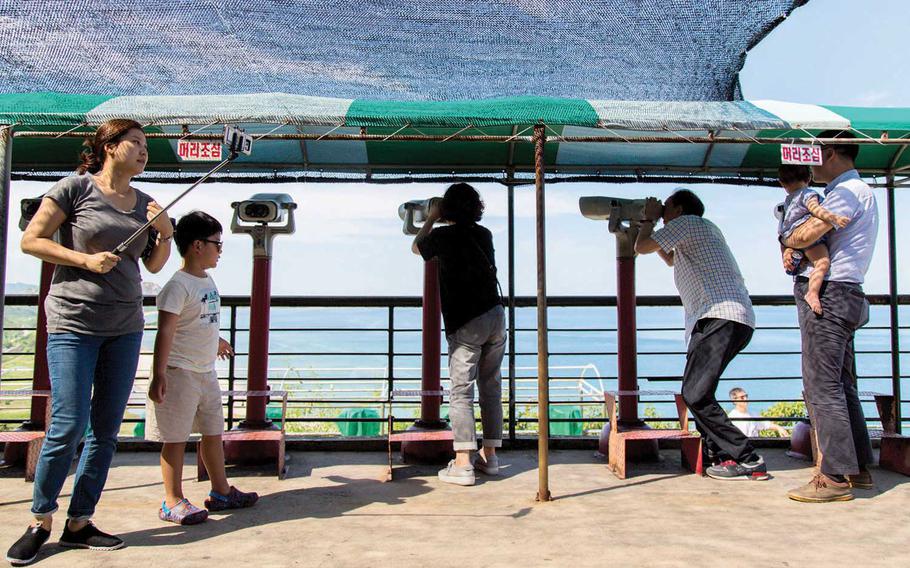 Tourists spy on North Korea near Goseong, South Korea, in the northeastern Gangwon province on Aug. 26, 2017. A man, intercepted at 7:20 a.m. by South Korean troops inside the civilian control line just south of the Demilitarized Zone, apparently swam some part of the way from North Korea in a dive suit before passing through a drain south the border in the northeastern Gangwon province.