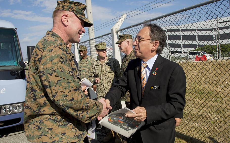 Okinawa Gov. Denny Tamaki speaks with Marine Corps Brig. Gen. Christopher McPhillips during a tour of Camp Kinser, Okinawa, Jan. 31, 2019.