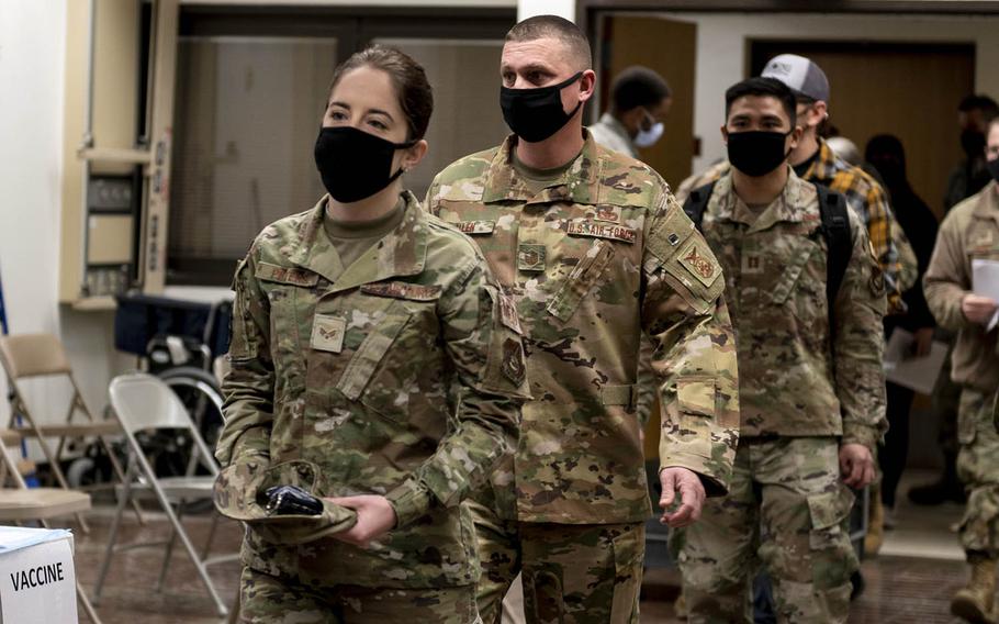 Service members wait to receive their first round of the Moderna COVID-19 vaccine at Osan Air Base, South Korea, Dec. 29, 2020.