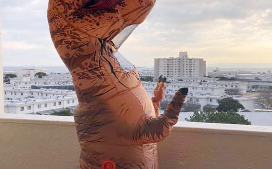 Seaman Isaiah Jackson, a crew member on the guided-missile destroyer USS Rafael Peralta, decided to have some fun during quarantine by donning an inflatable dinosaur suit and waving from his balcony at Yokosuka Naval Base, Japan.  