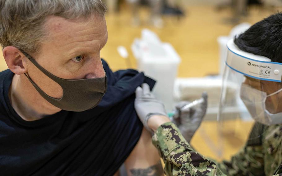 Cmdr. Andrew Wiese of the aircraft carrier USS Ronald Reagan receives his first dose of the Moderna COVID-19 vaccine at Yokosuka Naval Base, Japan, Jan. 7, 2021.
