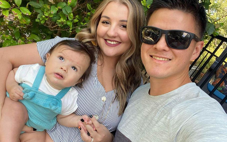 Brianne Engle poses with her husband, Air Force Tech. Sgt. Keith Engle, and their son, Lyam.