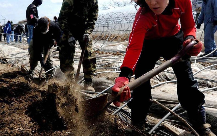 Students from Robert D. Edgren High School at Misawa Air Base help with cleanup efforts following the March 11, 2011, earthquake and tsunami that deveasted northeastern Japan. 