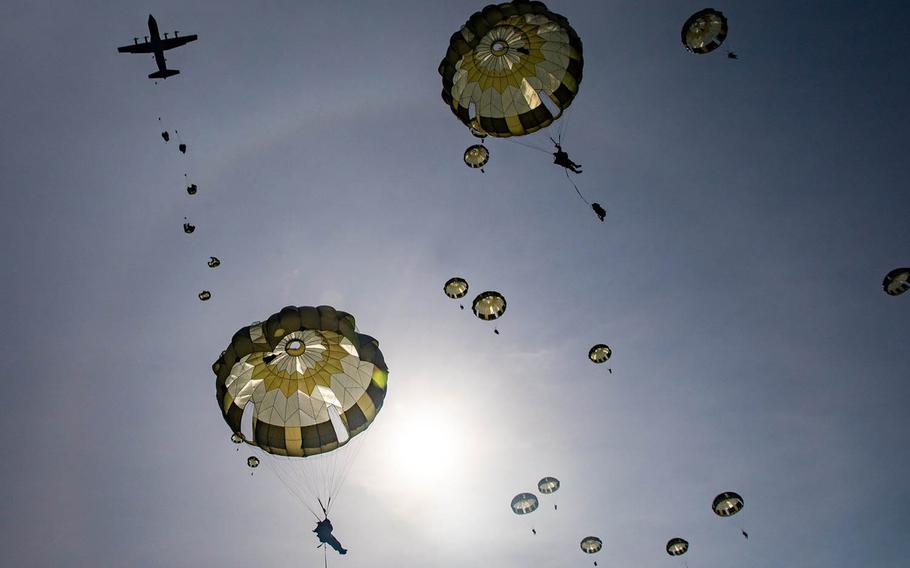 Japanese paratroopers jump from an Air Force C-130J Super Hercules at Combined Arms Training Center Camp Fuji, Japan, Tuesday, March 9, 2021.
