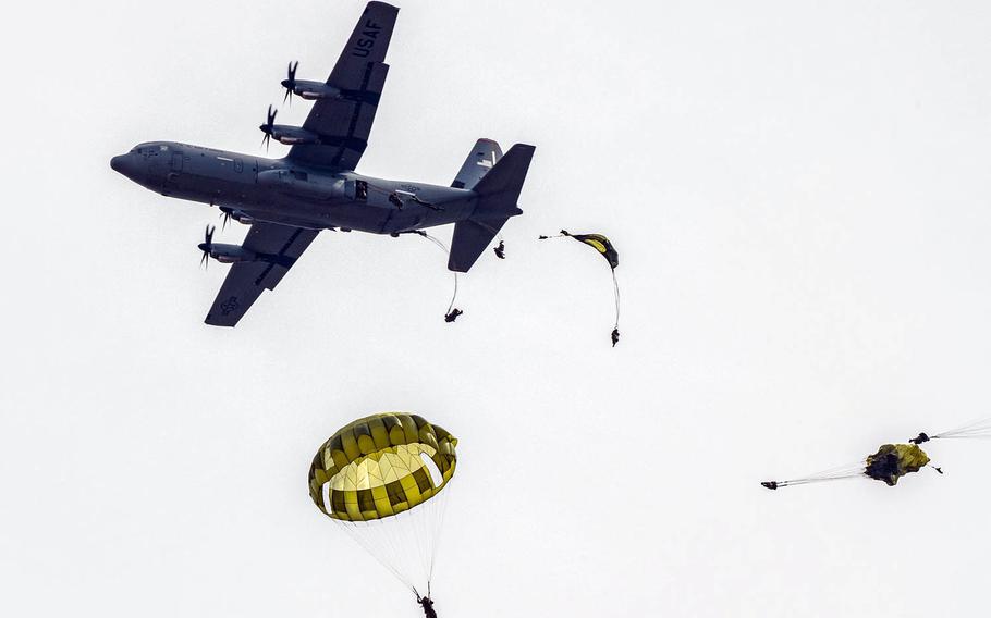 Japanese paratroopers jump from an Air Force C-130J Super Hercules at Combined Arms Training Center Camp Fuji, Japan, Tuesday, March 9, 2021.