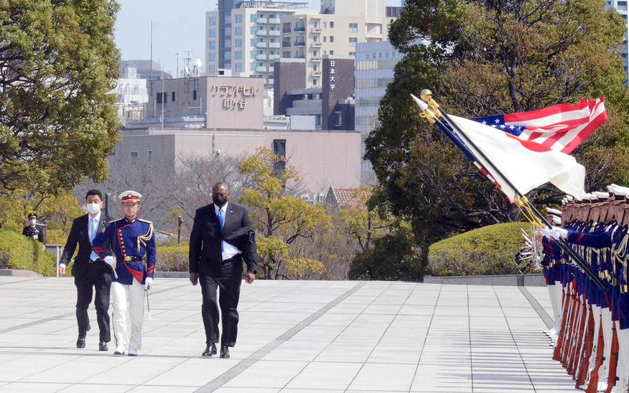 Secretary of Defense Lloyd Austin and Japanese Defense Minister Nobuo Kishi inspect troops at the Ministry of Defense in Tokyo, Tuesday, March 16, 2021.