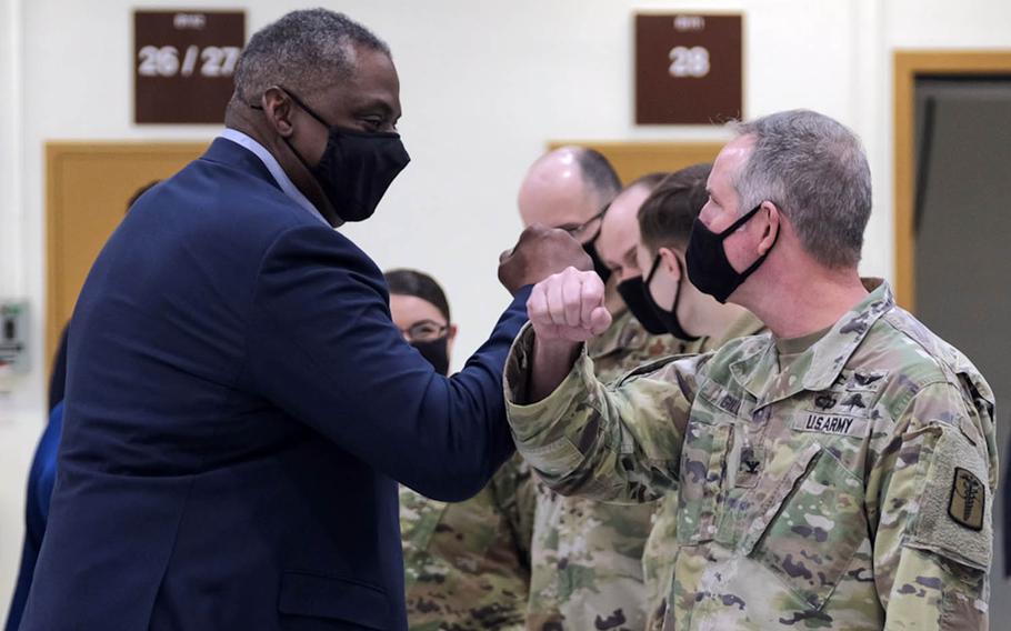 Defense Secretary Lloyd Austin greets a soldier with an arm bump at Osan Air Base, South Korea, Friday, March 19, 2021.