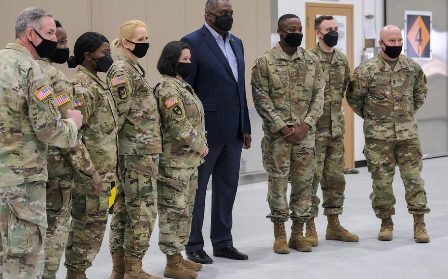 Defense Secretary Lloyd Austin poses for a photo with service members minutes before departing Osan Air Base, South Korea, Friday, March 19, 2021.