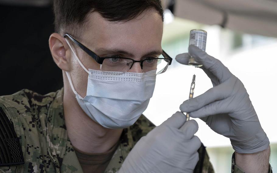 A hospitalman fills a syringe with the Moderna COVID-19 vaccine at Naval Hospital Okinawa on Camp Foster, Jan. 27, 2021. 
