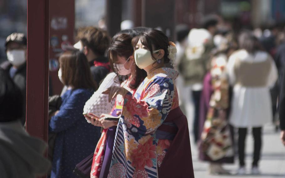 Protective masks are still part of the pandemic wardrobe in Tokyo, even for these women in traditional attire near Sensoji temple on March 17, 2021. 