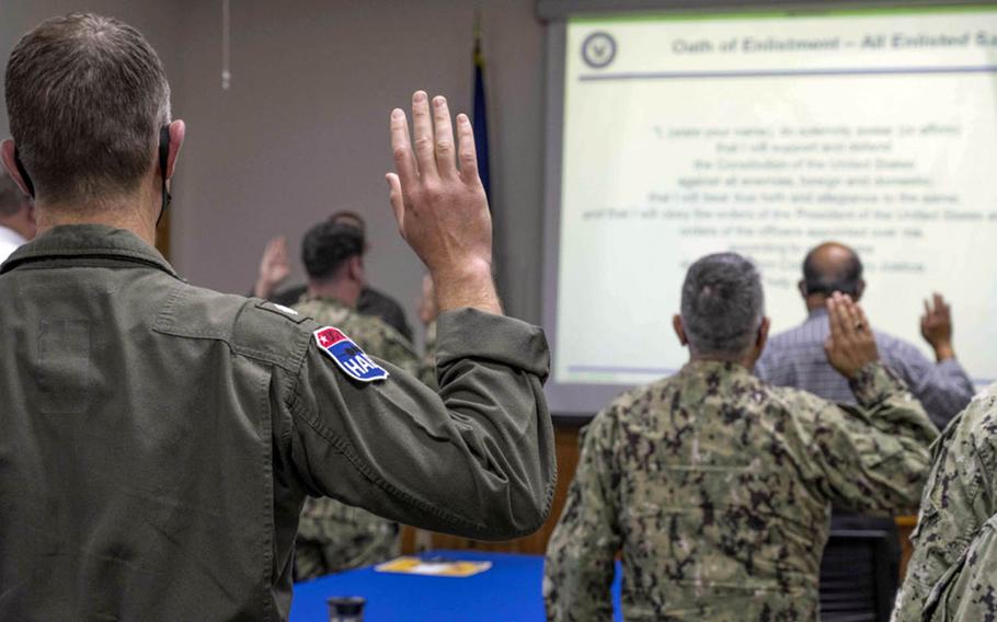 Service members and civilians reaffirm their oaths of office and enlistment during extremism training at Kadena Air Base, Okinawa, March 8, 2021. 