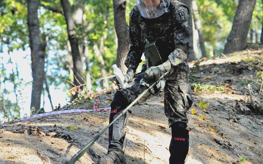 A South Korean soldier works a metal detector at Arrowhead Hill in the Demilitarized Zone in a hunt for leftover mines of the Korean War on Oct. 8, 2018.