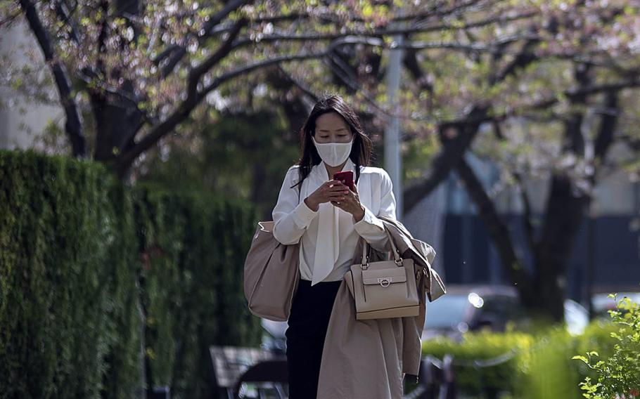 A week after the lift up of the state of emergency, many people wearing masks are strolling around Tokyo Midtown in Roppongi. 