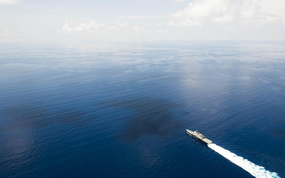 The littoral combat ship USS Fort Worth, trailed by a Chinese guided-missile frigate, sails near the Spratly Islands in the South China Sea, May 11, 2015. 