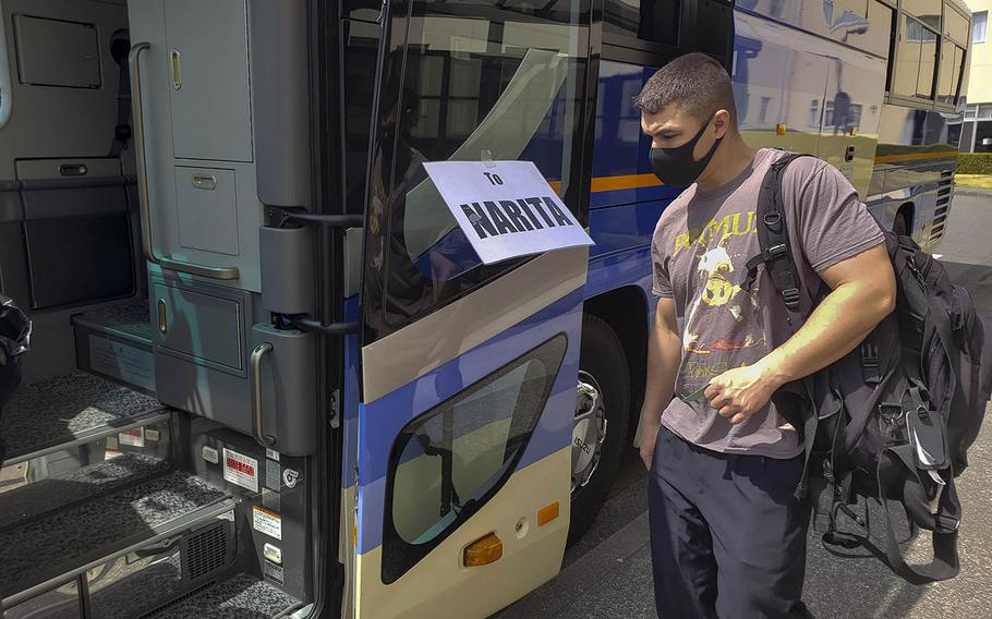 A service member boards a bus to Narita International Airport at Yokota Air Base, Japan, April 1, 2021. 