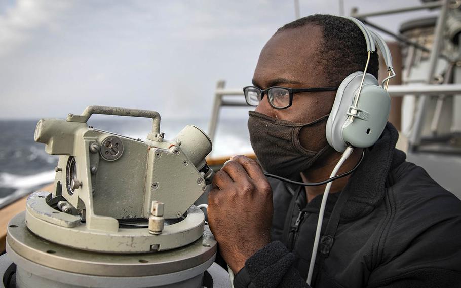 Seaman James Bailey of Greenville, S.C., stands watch on the bridge of the guided-missile destroyer USS John S. McCain in the Taiwan Strait, Wednesday, April 7, 2021.