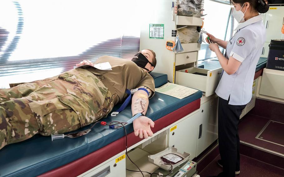 Army Master Sgt. Susan Francis, 36, donates blood to the Korean Red Cross at Camp Humphreys, South Korea, Wednesday, April 7, 2021.