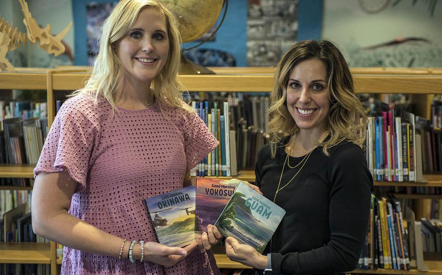 Navy wives Amy Dobbins, left, and Sarah Murphy show off the three installments of their "Good Morning Military" children's book series at Yokota Air Base, Japan, Thursday, April 8, 2021.