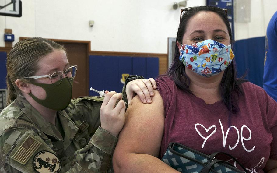Kimberly Hipp, 37, an Air Force dependent from North Carolina, receives her second dose of the Moderna coronavirus vaccine at Kadena Air Base, Okinawa, Friday, April 9, 2021.