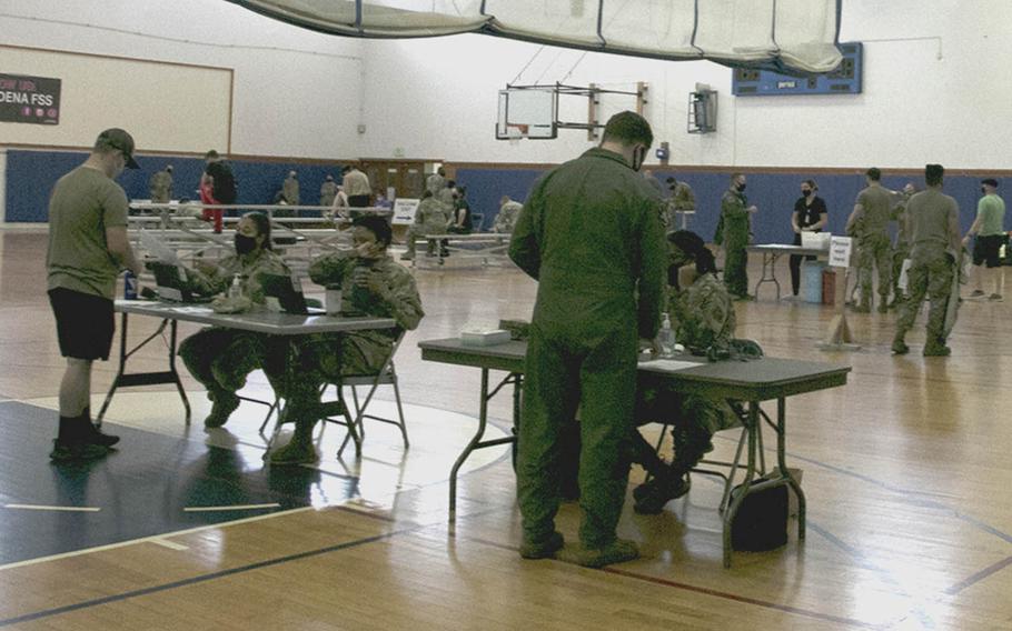 People check in to receive the coronavirus vaccine at the Risner Fitness and Sports Complex on Kadena Air Base, Okinawa, Friday, April 9, 2021.