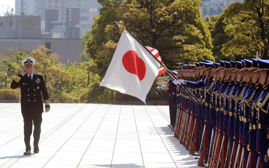 The head of U.S. Indo-Pacific Command, Adm. Philip Davidson, reviews Japanese troops outside the Ministry of Defense in Tokyo, Monday, April 12, 2021. 