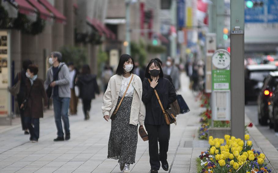 People wear masks as protection against the coronavirus in central Tokyo, April 6, 2021.