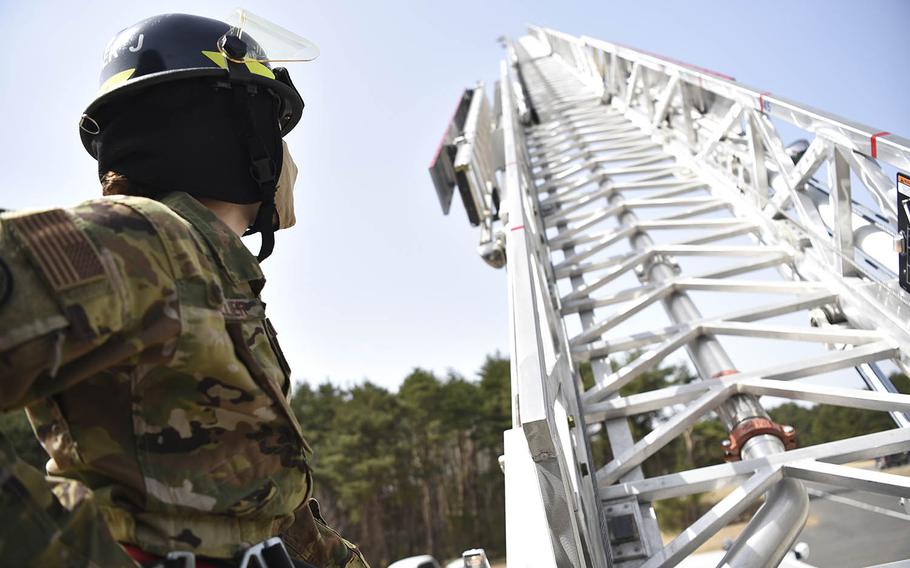 Air Force Staff Sgt. Journey Collier, a 35th Civil Engineer Squadron firefighter, raises a fire truck ladder at Misawa Air Base, Japan, March 31, 2021. 