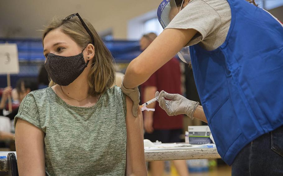 The daughter of a service member stationed at Yokota Air Base in western Tokyo receives the Moderna COVID-19 vaccine during a shot clinic at Yokosuka Naval Base, Japan, Wednesday, April 21, 2021. 
