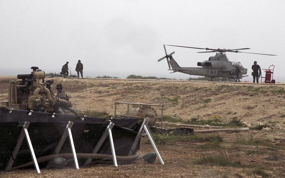 Members of Marine Wing Support Squadron 172 refuel an AH-1Z Viper attack helicopter on a makeshift landing pad on Ie Shima, Okinawa, April 16, 2021.