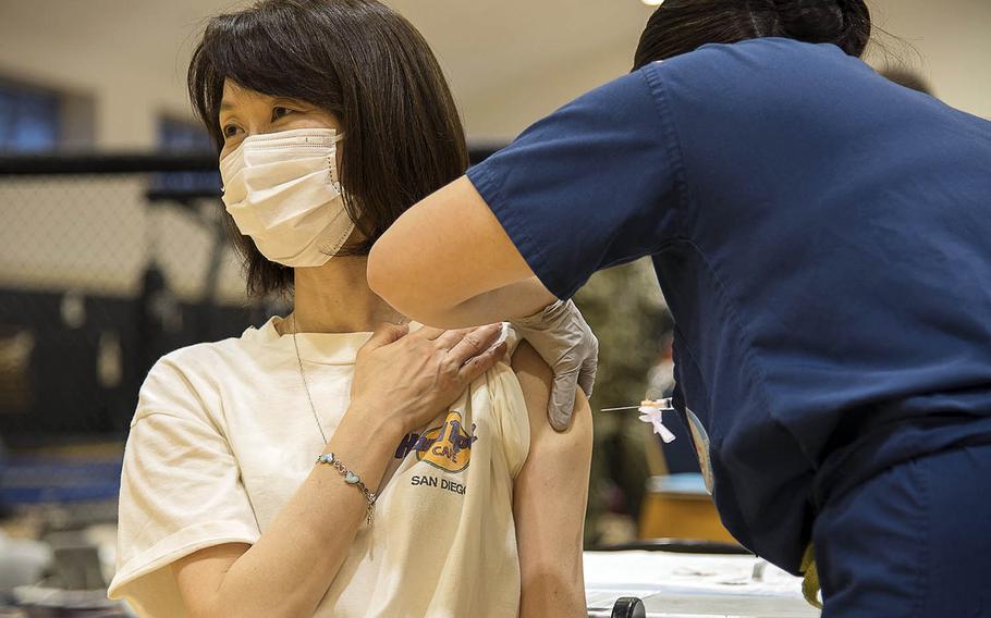 Rikako Park the wife of retired Navy captain Brian Park, receives a dose of the Moderna coronavirus vaccine at Yokosuka Naval Base, Japan, April 21, 2021. 