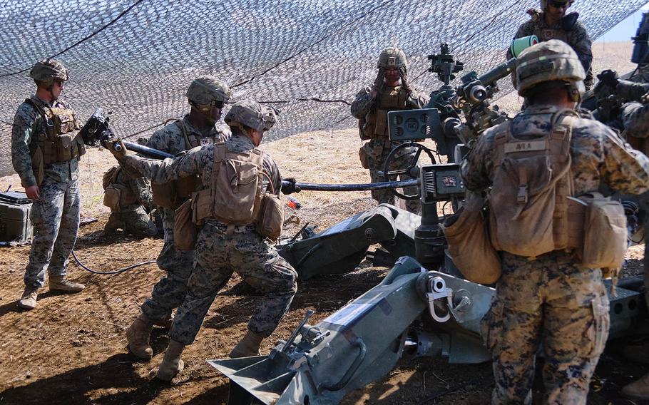 Members of 3rd Battalion, 12th Marine Regiment, 3rd Marine Division prepare to fire an M777 A2 howitzer during artillery relocation training at Camp Fuji, Japan, April 23, 2021.  