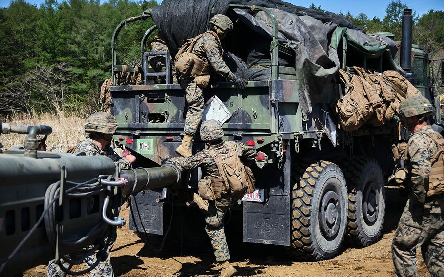 Members of 3rd Battalion, 12th Marine Regiment, 3rd Marine Division take an M777 A2 howitzer to a new firing position, during artillery relocation training at Camp Fuji, Japan, April 23, 2021.  