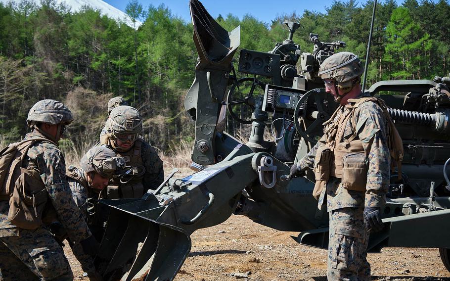 Members of 3rd Battalion, 12th Marine Regiment, 3rd Marine Division prepare to take an M777 A2 howitzer to a new firing position, during artillery relocation training at Camp Fuji, Japan, April 23, 2021.  