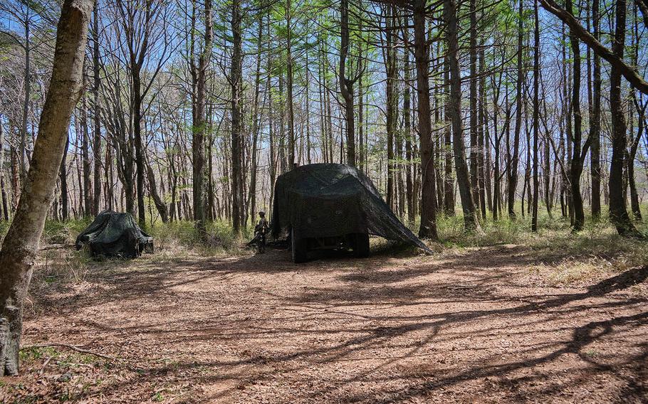 Members of 3rd Battalion, 12th Marine Regiment, 3rd Marine Division hide artillery, including an M142 High Mobility Artillery Rocket System, or HIMARS, during a survivability exercise at Camp Fuji, Japan, April 23, 2021.  