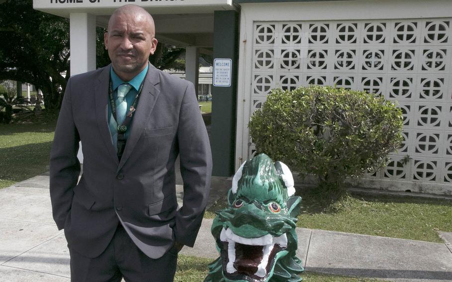 Kubasaki High School principal James Strait poses in front of his school at Camp Foster, Okinawa, Monday, April 26, 2021. Strait has been named Principal of the Year by Department of Defense Education Activity.