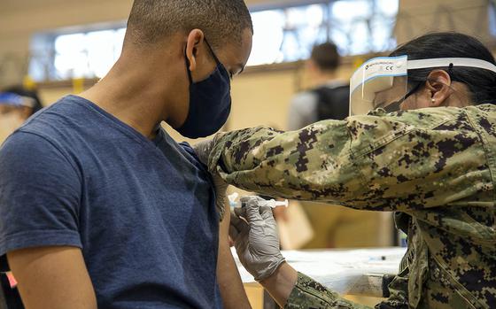 Seaman Delano Freeman of the USS Blue Ridge receives a dose of the Moderna coronavirus vaccine at Yokosuka Naval Base, Japan, April 21, 2021. 