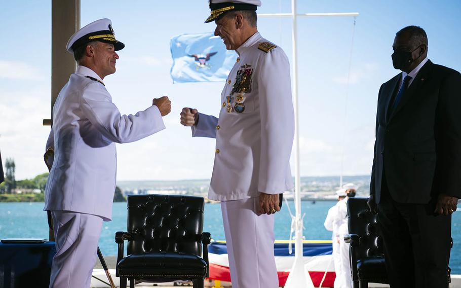 Adm. John Aquilino, left, relieves Adm. Philip Davidson, center, as leader of U.S. Indo-Pacific Command, during a ceremony at Joint Base Pearl Harbor-Hickam, Hawaii, Friday, April 30, 2021. Defense Secretary Lloyd Austin stands at right. 