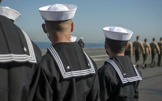 Sailors prepare to man the rails of the aircraft carrier USS Nimitz in San Diego, Feb. 26, 2021. 