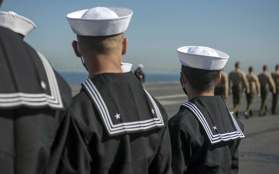 Sailors prepare to man the rails of the aircraft carrier USS Nimitz in San Diego, Feb. 26, 2021. 