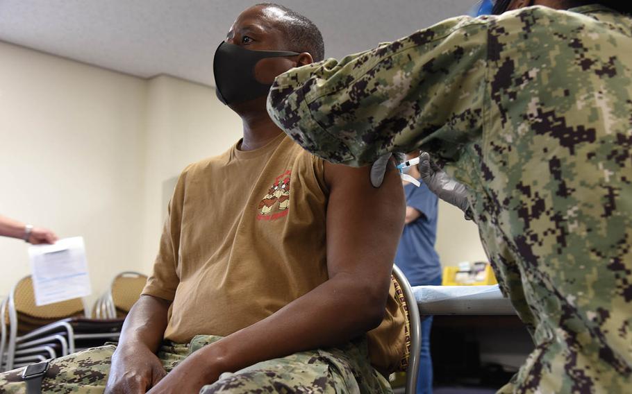 Chief Petty Officer Harold Wilson receives a coronavirus vaccine at Naval Air Facility Atsugi, Japan, Friday, May 7, 2021.