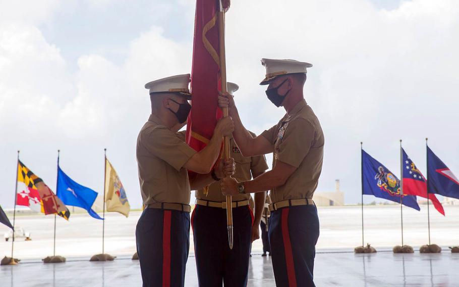 Col. Bradley Magrath, right, passes the unit colors to Col. Christopher Bopp during the first change-of-command ceremony for Marine Corps Base Camp Blaz, Guam, Friday, May 7, 2021. 